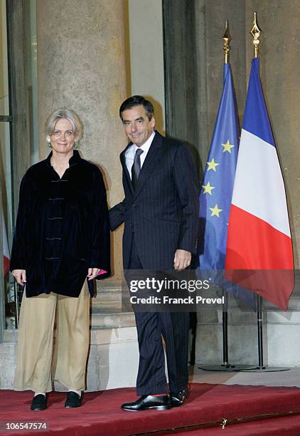 France's Prime Minister Francois Fillon with his wife arrives to attend a state dinner honouring visiting Chinese President Hu Jintao at Elysee...