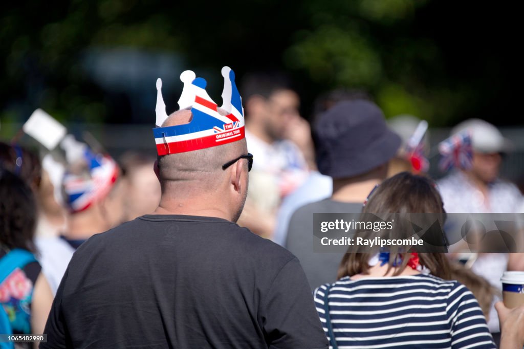 Man wearing a paper union Jack hat while celebrating the marriage of Meghan Markle and Prince Harry at St George's Chapel at Windsor Castle.