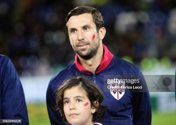 Darjio Srna of Cagliari stands on the pitch with a red mark on his face to symbolise the fight against violence against women ahead ofthe Serie A...
