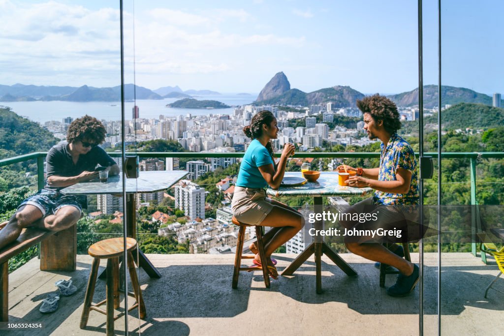 Brazilian couple on terrace,  Sugar loaf Mountain in background