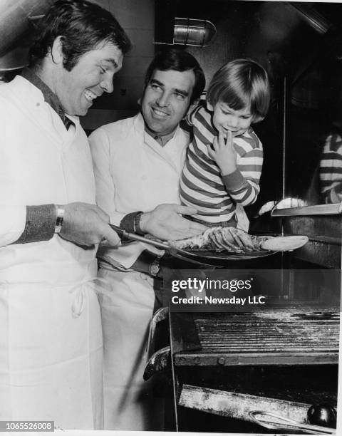 Mets Ed Kranepool and Yankees Ron Swoboda cook up a lobster to the delight of Kranepool's son at the restaurant the former teammates co-own, "The...