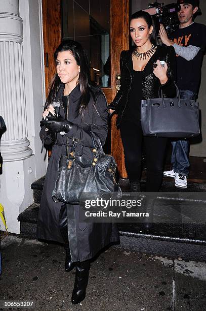 Television personalities Kourtney Kardashian and Kim Kardashian leave their Dash Soho clothing store on November 4, 2010 in New York City.