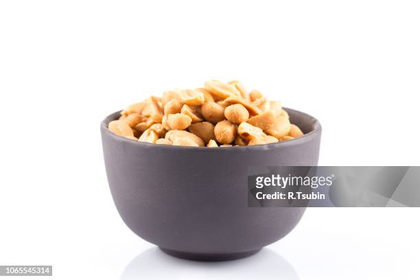 peanut nuts salt in bowl isolated on white background - peanuts stock pictures, royalty-free photos & images