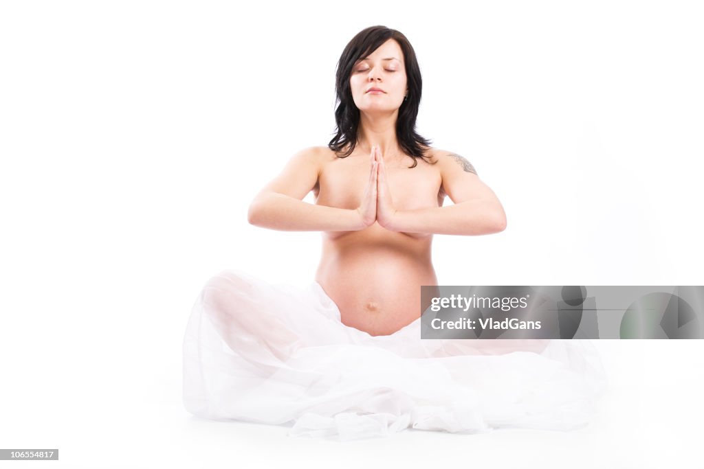 Young pregnancy woman performing yoga meditation