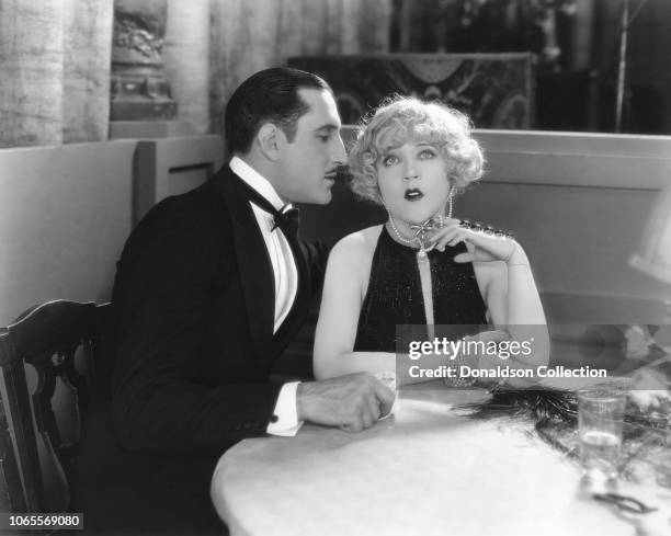 Actress Mae Murray and Basil Rathbone in a scene from the movie "The Masked Bride"