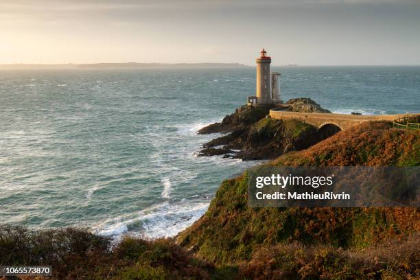 sunrise in "rade de brest" in the front of the petit minou lighthouse - brest stock pictures, royalty-free photos & images