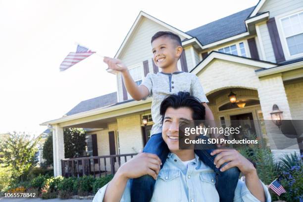 patriotic father and son - suburban lifestyles stock pictures, royalty-free photos & images