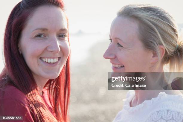 portrait smiling lesbian couple - lesbian beach wedding stock pictures, royalty-free photos & images