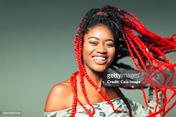 Portrait confident, carefree young woman with red braids
