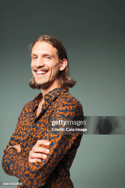portrait smiling, confident young man with handlebar mustache - handlebar moustache stock pictures, royalty-free photos & images
