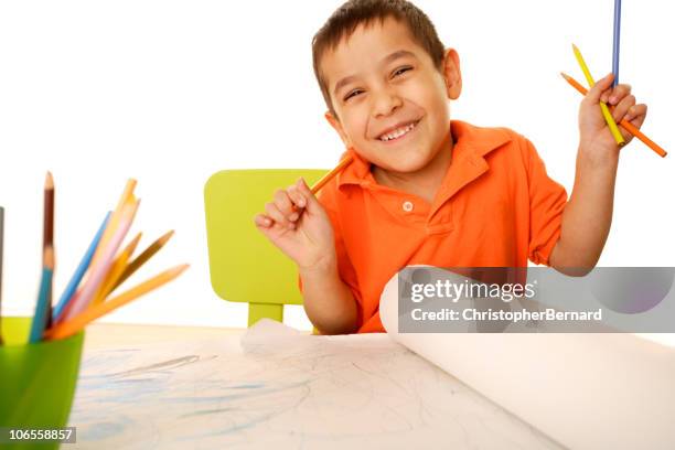 playschool - kid holding crayons stockfoto's en -beelden