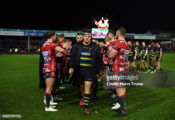 The Northampton Saints side cut dejected figures as they make their way through a tunnel of Gloucester Rugby players during the Premiership Rugby Cup...