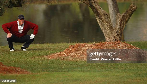 Mike Clayton of the USAprepares to play his second shot from behind a tree on the fifth hole during the first round of the OKI Castellon Senior Tour...