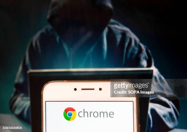 In this photo illustration, the American web browser developed by Google, Chrome,logo is seen displayed on an Android mobile device with a figure of...