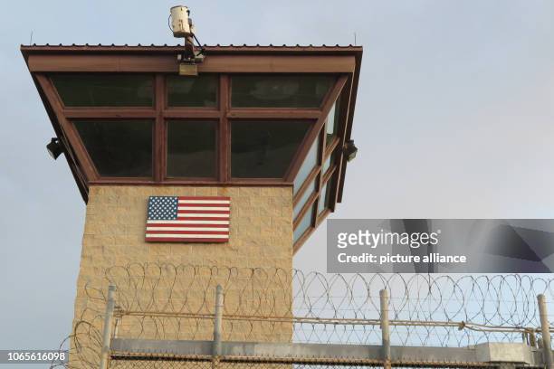 October 2018, Cuba, Guantanamo Bay: A watchtower stands behind a barbed wire fence. The infamous camp has now existed for almost 17 years. 40 inmates...