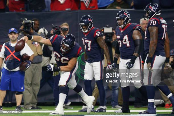 Nick Martin of the Houston Texans spikes the ball after a touchdown by Deshaun Watson in the second quarter against the Tennessee Titans at NRG...
