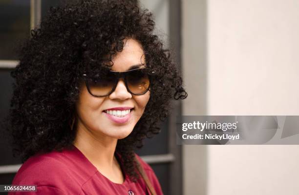 beautiful woman smiling wearing sunglasses - maroon hair stock pictures, royalty-free photos & images