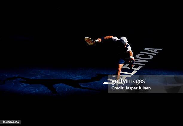 Juan Monaco of Argentina runs to play a backhand to Marcel Granollers of Spain in his quarter final match during the ATP 500 World Tour Valencia Open...