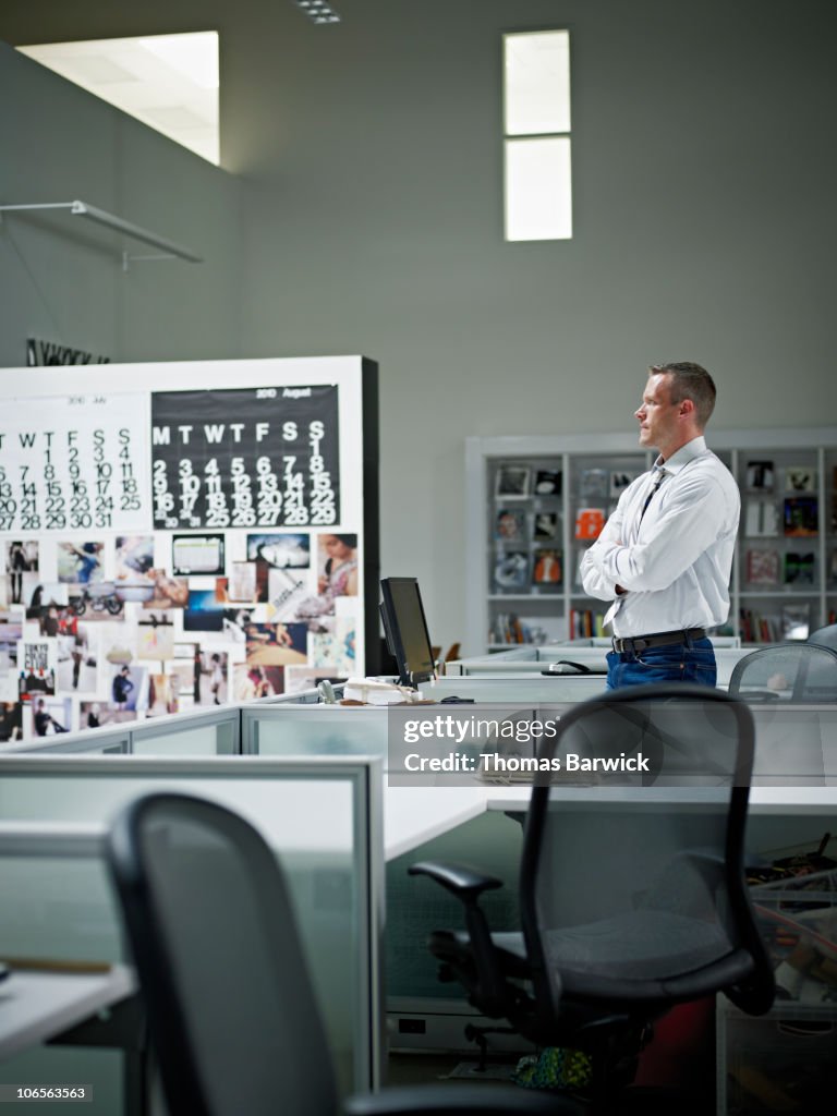 Businessman standing at desk in design office