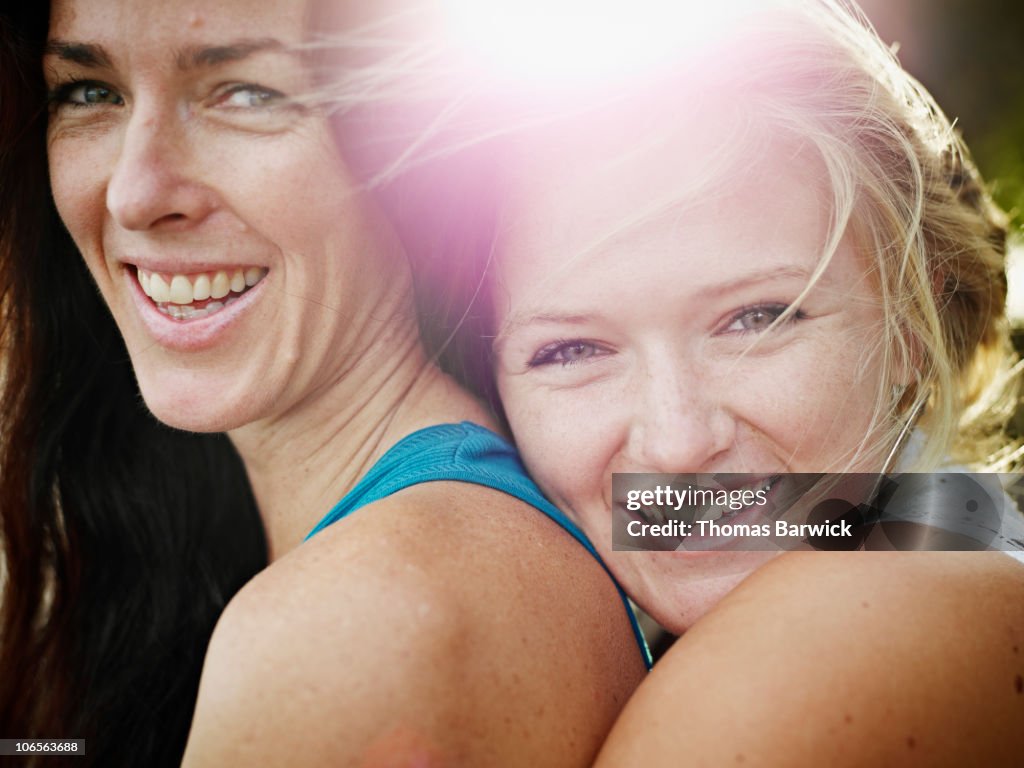 Mother and daughter embracing smiling