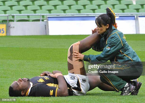 Tendai Mtawarira of South Africa stretches with the help of physio Rene Naylor during a Springboks training session at Aviva Stadium on November 05,...