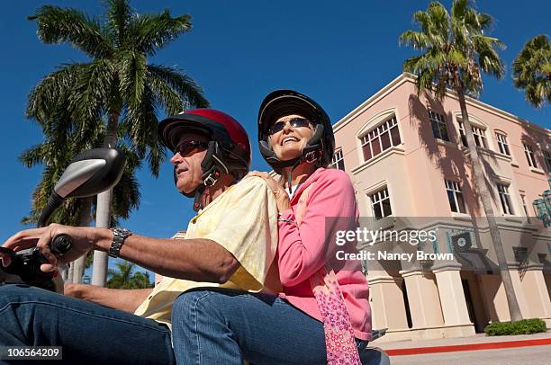 senior caucasian couple on motor scooter.. - boca raton florida imagens e fotografias de stock
