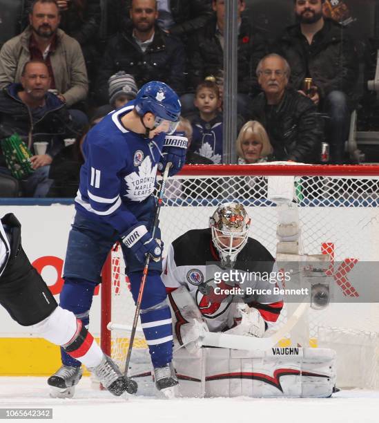 Zach Hyman of the Toronto Maple Leafs attempts to deflect a puck past Keith Kinkaid of the New Jersey Devils during the first period at the...