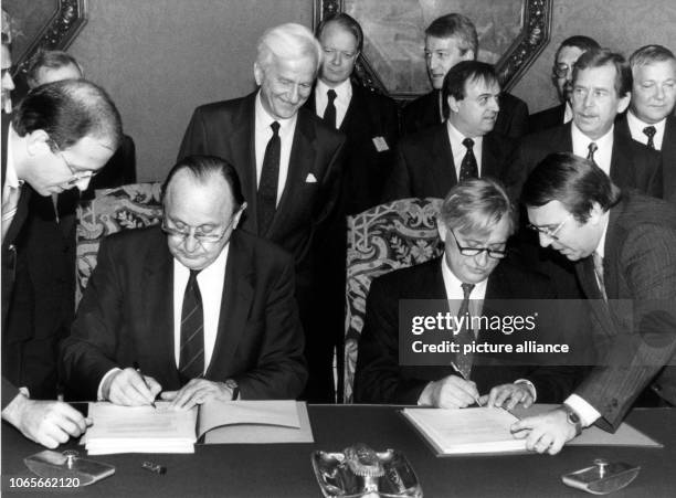 German Foreign Minister Hans-Dietrich Genscher and Czechoslovakian Foreign Minister Jiri Dienstbier sign a German-Czechoslovakian neighboring...