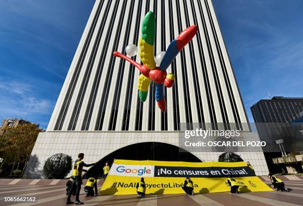 Amnesty International activists hold a giant dragonfly-shaped balloon with a banner reading "Google, do not censor in China, no to the Dragonfly...