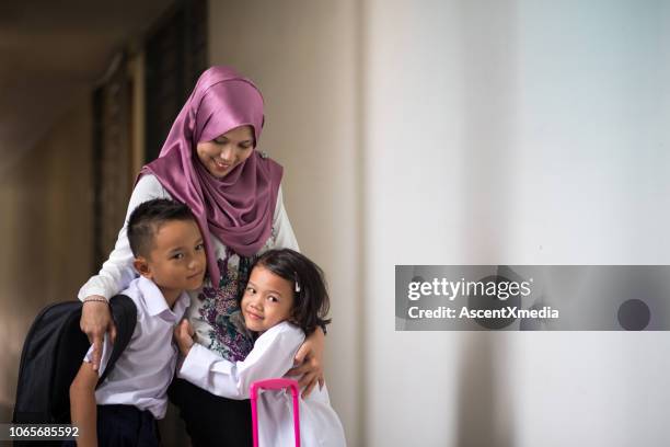 parents getting their kids to school - malaysia school stock pictures, royalty-free photos & images