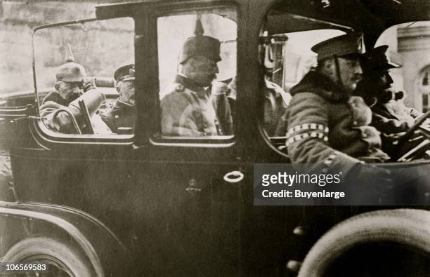 Kaiser Wilhelm II of Germany and his brother Prince Henry of Prussia ride in the back of a car with unidentified others, Germany, 1910s.
