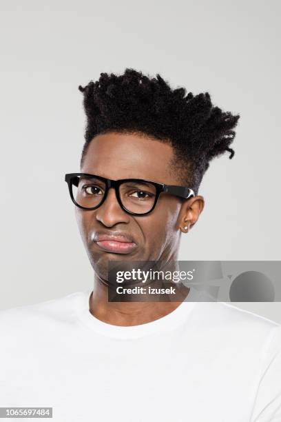 close up of disgusted afro american man - disgust face stock pictures, royalty-free photos & images
