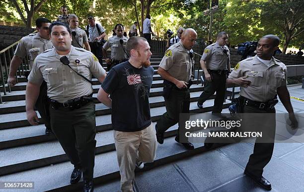 Sheriff's deputies detain a passerby after scufflling with members of the Black Riders Liberation Front who are supporters of slain transit passenger...