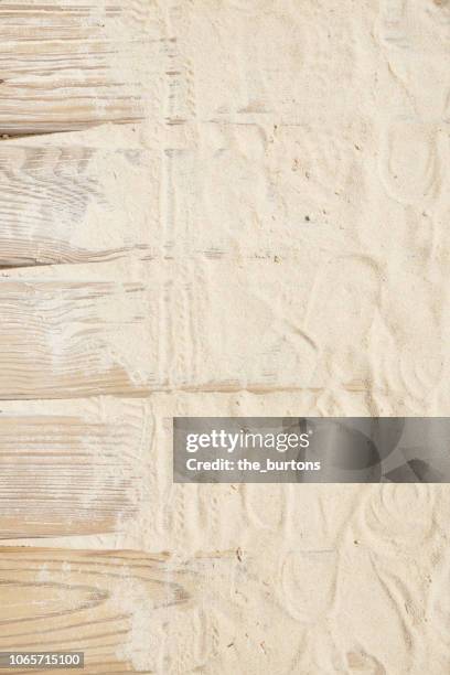 high angle view of boardwalk with sand and footprints - footsteps on a boardwalk bildbanksfoton och bilder