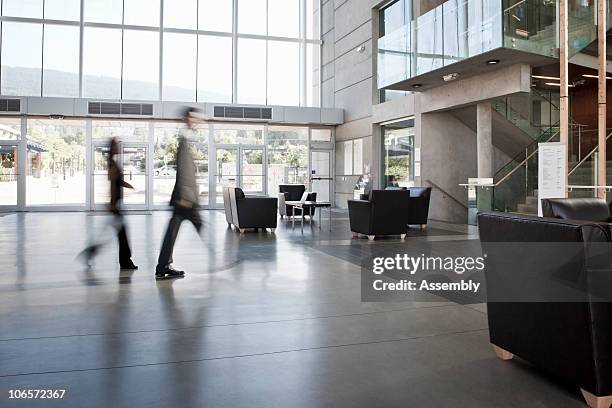 business colleagues blurred walking through office - lobby stock pictures, royalty-free photos & images