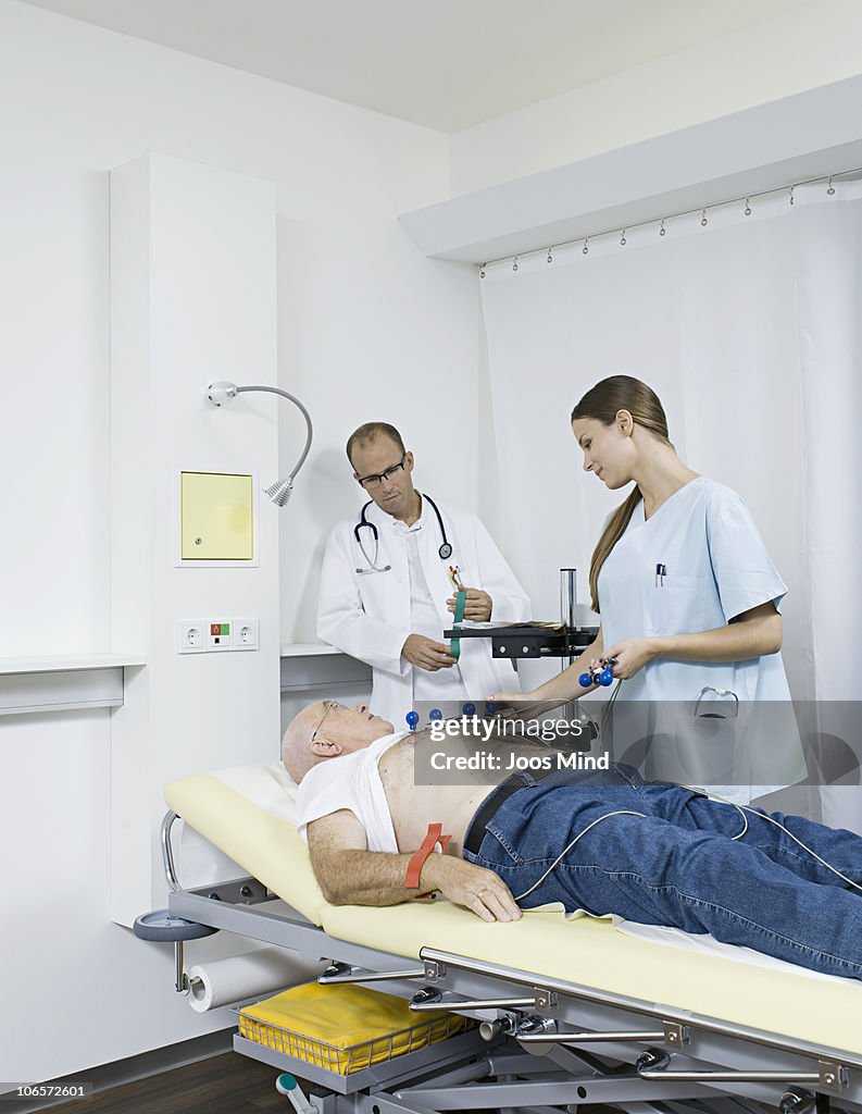 Senior man receiving electrocardiogram