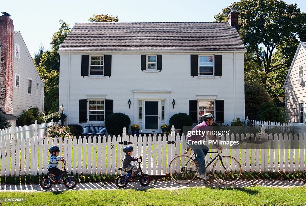 Father and twin sons on bike ride