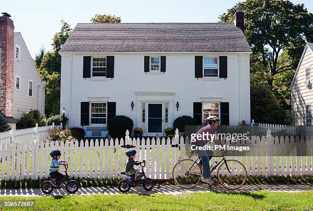 father and twin sons on bike ride - caucasian family outdoor stock pictures, royalty-free photos & images