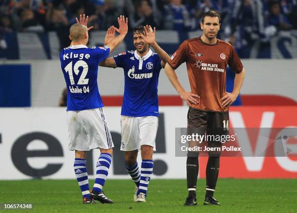 Raul of Schalke celebrates with his team mate Peer Kluge after scoring his team's third goal during the Bundesliga match between FC Schalke 04 and FC...