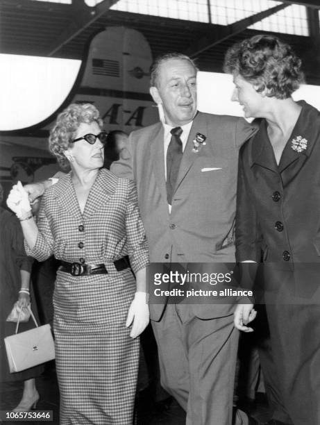 Walt Disney, wife Lillian Marie Disney and the chief of protocol of the film festival, Mrs Succar, arriving at Berlin Tempelhof airport on 30 June...