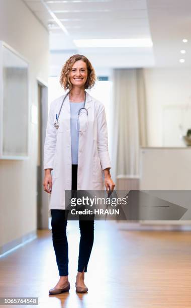 ritratto di medico donna sorridente con appunti - doctor standing foto e immagini stock