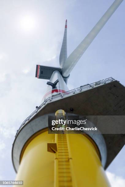 manuell hög arbetstagare offshore klättring på vindkraftverk på stege - wind bildbanksfoton och bilder