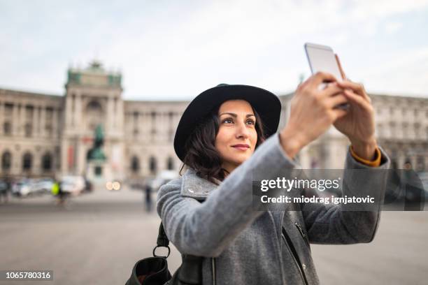 beautiful stylish woman taking photos in vienna - hofburg wien stock pictures, royalty-free photos & images