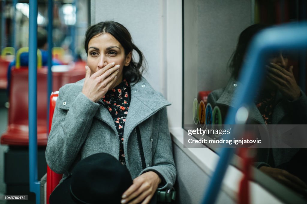 Tired woman in public transportation