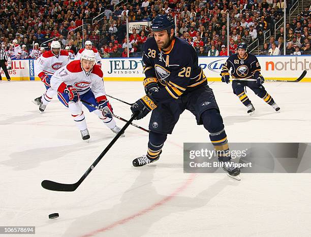 Paul Gaustad of the Buffalo Sabres controls the puck against Dustin Boyd of the Montreal Canadiens at HSBC Arena on November 5, 2010 in Buffalo, New...