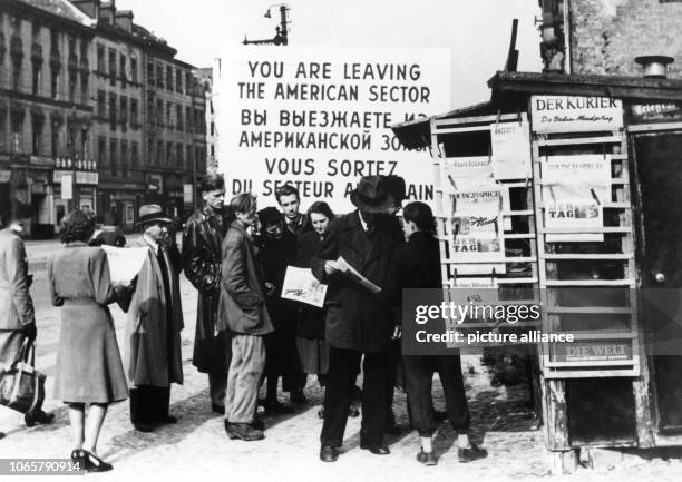 After banning the sale of western licensed newspaper through the SMA in the eastern part of Berlin, people are shoving around a newsstand near the...