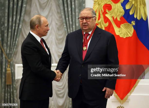 Russian President Vladimir Putin greets billionaire and businessman Alisher Usmanov during the State Awards Ceremony at the Kremln in Moscow,...