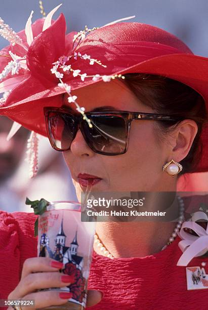 Kentucky Derby: Closeup of female fan wearing hat and drinking mint julep during race at Churchill Downs. Louisville, KY 5/7/1988 CREDIT: Heinz...