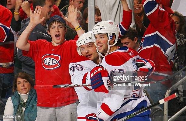 Andrei Markov, and Benoit Pouliot of the Montreal Canadiens celebrate Pouliot's second goal of the game against the Buffalo Sabres at HSBC Arena on...