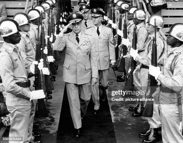 General Lyman L. Lemnitzer , commander-in-chief of the NATO forces in Europe, passing honor guards at the beginning of the celebration of the 20th...